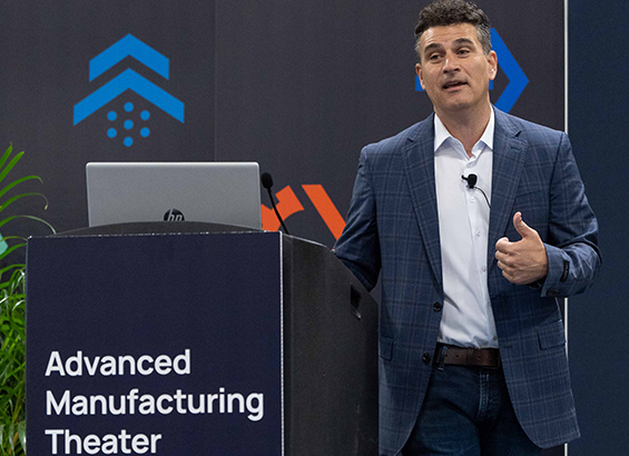 A male speaker presenting at the Advanced Manufacturing Theater